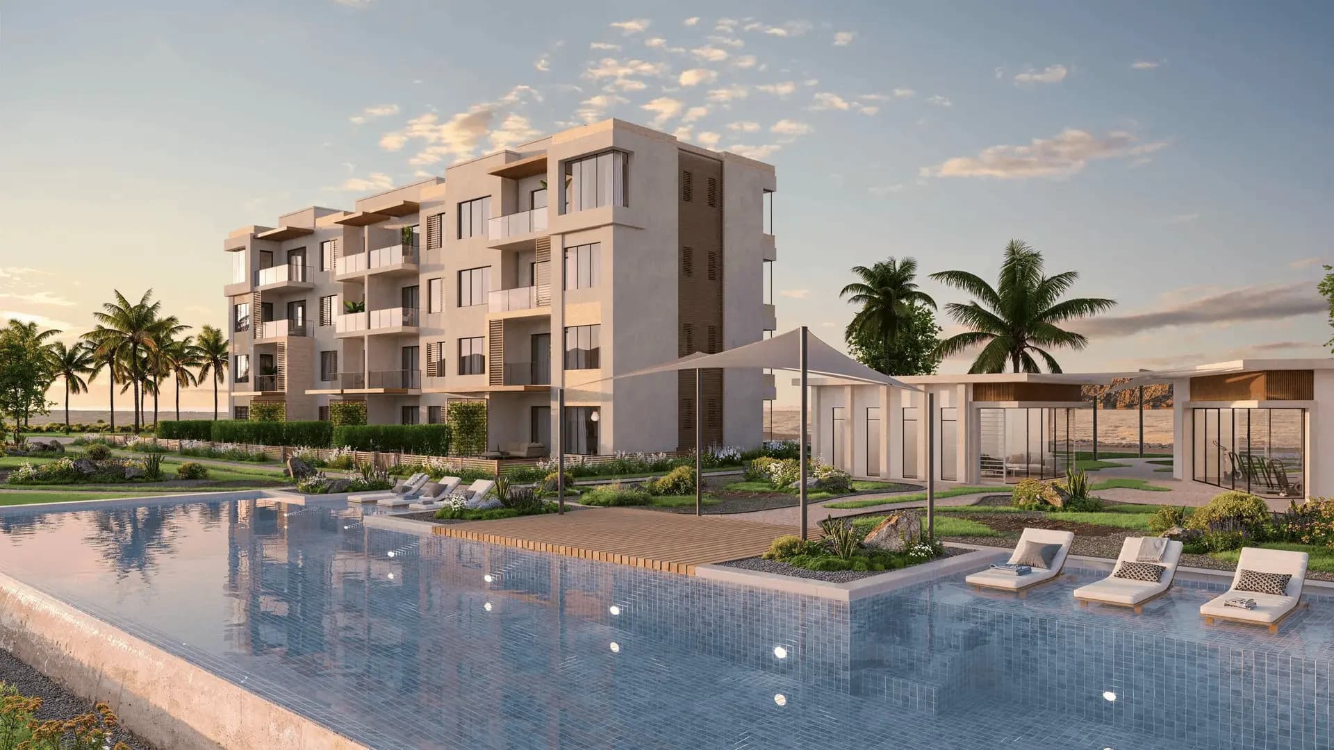 White apartment blocks around a pool, palms behind them